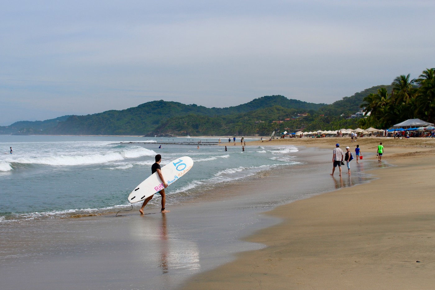 surfer-walking-on-sayulita-beach
